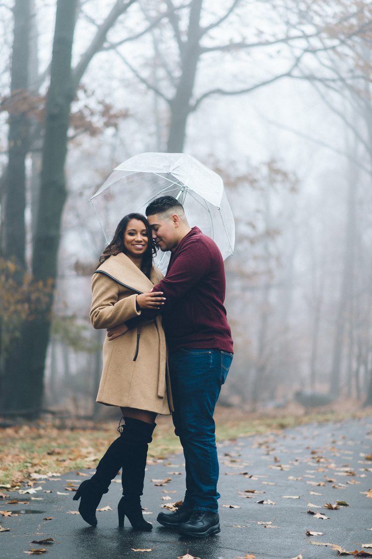 Fort Lee Historic Park, NJ Engagement Session with Ashley and Chris. The light rain and the fog actually worked out great for photo shoot, making the background mysterious and giving the photo deep & rich colors. Ashley and Chris’ romantic rainy engagement session in Fort Lee, NJ captured by Steve from Pearl Paper Studio, NY, NJ and destination wedding photography studio Pearl Paper Studio. Documenting fun and energetic weddings, while telling a story with our cameras. We are group of story tellers with our cameras.