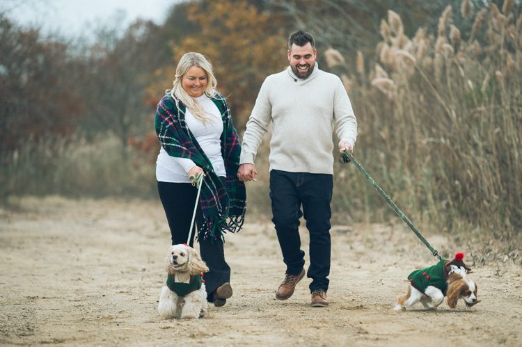 Cozy home session with Christie and Jay along with their two fur babies all dolled up in their holiday clothing! We love when our clients bring out their fur babies for their engagement session. Christie and Jay had the perfect idea for their engagement session which did not involve too much planning instead they focused on them and the photos came out fabulous. Christie and Jay just walked around their neighborhood in Keyport, NJ. Took a stroll along the winter ocean enjoying the brisk air, ocean, sand and then warmed up at their home w their pups. Christie and Jay’s home engagement session captured by Steve from Pearl Paper Studio. Pearl Paper Studio wedding photography studio covering New Jersey, New York and Long Island brides and our passion is to photograph fun, warm and energetic couples on their very special wedding day.