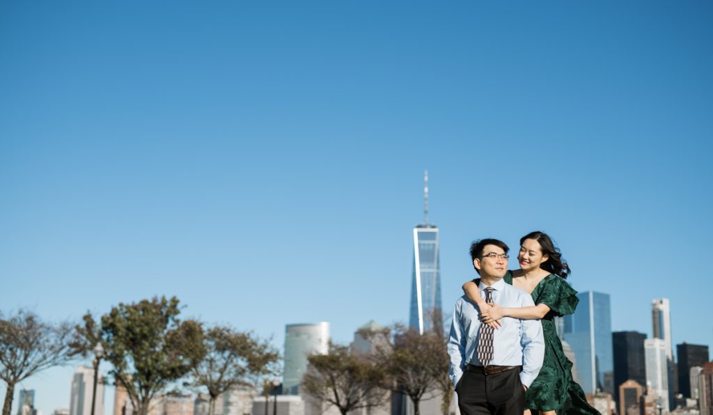 You get the best view and skyline of NYC from Liberty State Park in Jersey City. Follow the brick pathway all the down Audrey Zapp Drive in Jersey City you will arrive a Liberty State Park where you'll be greeted with 911 Memorial and historic Ferry Terminal. We met Kari and Leon at Liberty State Park for their engagement session during later afternoon to catch the sunset and oh how gorgeous what the lighting during Kari and Leon's engagement session at Liberty State Park. Liberty State Park Kari and Leon Engagement captured by Steve from Pearl Paper Studio. Pearl Paper Studio is here to capture real emotions, fun couples with non-traditional wedding stories, now we are booking small intimate backyard wedding, outdoor tent wedding, farm wedding, elopements, nyc elopements. We are currently booking fall 2022 and 2023 weddings in NY, NJ and LI.