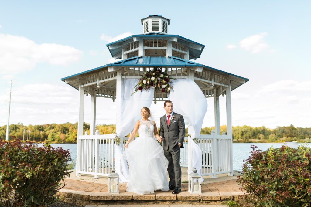 Sara and Dylan's gorgeous fall wedding at Boathouse at Mercer Lake in West Windsor Township, NJ. This beautiful waterfront wedding venue gives you the most gorgeous sunset at the end of the evening giving that perfect opportunity for the night shot to wrap up the magical wedding day.  Boathouse at Mercer Lake in West Windsor Township, NJ wedding celebrating Sara and Dylan captured by Steve from Pearl Paper Studio. Pearl Paper Studio is here to capture real emotions, fun couples with non-traditional wedding stories, now we are booking small intimate backyard wedding, outdoor tent wedding, farm wedding, elopements, nyc elopements. We are currently booking fall 2022 and 2023 weddings in NY, NJ and LI.
