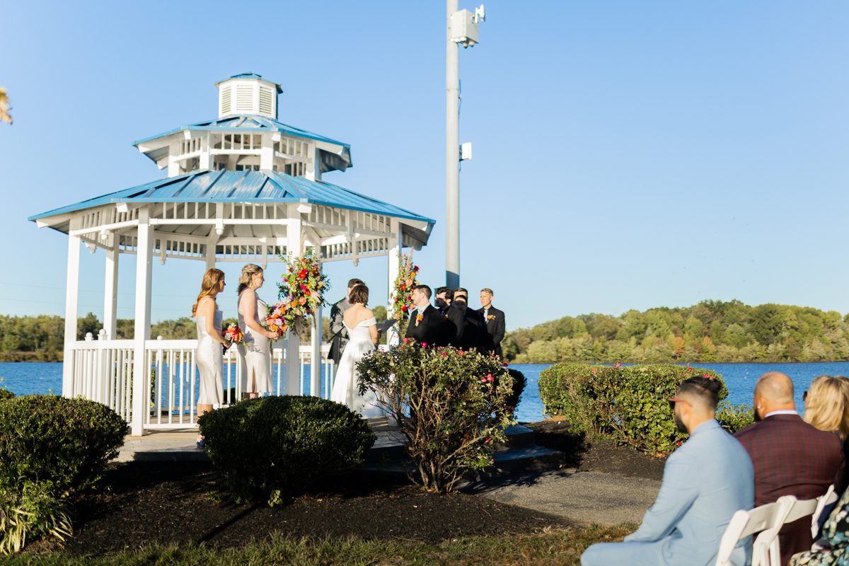 On September 24th, 2022 Jade and Michael got married at The Boathouse at Mercer Lake in West Windsor Township, NJ. Our lead photographer MJ with second photographer Ann went to capture Jade and Michael's wedding at The Boathouse at Mercer Lake. The couple Jade and Michael got ready at Hilton Garden Inn at Lawrenceville, NJ then arrived at The Boathouse at Mercer Lake in the afternoon for bride and groom first look followed by all the formal photos with their bridal party by the Mercer Lake. Jade and Michael's outdoor wedding ceremony by The Boathouse at Mercer Lake was held at 5pm and we still had enough daylight for some more family photos after the ceremony. Once the cocktail hour began wedding guests enjoyed themselves with drinks and good food. Jade and Michael's wedding reception was over at 11pm at The Boathouse at Mercer Lake on beautiful September. Jade and Michael's wedding at The Boathouse at Mercer Lake, West Windsor Township, NJ captured by MJ from Pearl Paper Studio. Pearl Paper Studio is here to capture real emotions, fun couples with non-traditional wedding stories, now we are booking small intimate backyard wedding, outdoor tent wedding, farm wedding, elopements, nyc elopements. We are currently booking fall 2022 and 2023 weddings in NJ, NY, Brooklyn and Long Island.
