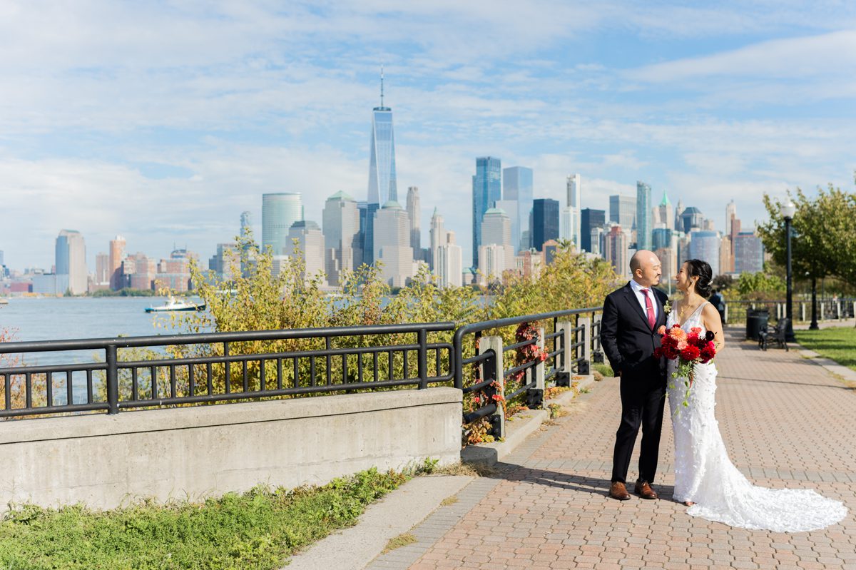 There is pros and cons to a daytime wedding, pro is that you are done early enough where you can enjoy dinner at home with your family. Con of course is that you have to wake up earlier that your normal evening reception. Sara and Eric's Liberty House wedding in Jersey City NJ this past October was indeed a daytime wedding where our day started at 7am. Sara and Eric got an airbnb on Hudson Street Jersey City to get ready. Sara and Eric's first look took place at Liberty State Park on Audrey Zapp Drive next to Liberty House Restaurant, then we did bridal party and couple's portraits all before their wedding ceremony at Liberty House. Outdoor wedding ceremony starting at noon over looking NYC, Sara and Eric wedding with gorgeous floral designed by Made of Leaves said their vows and walked down the aisle as husband and wife! Sara wore her Chinese red dress made by East Meets Dress for the wedding ceremony then switched to her white wedding dress from Lovely Bride for her wedding reception. Sara and Eric incorporated their chinese heritage to their wedding day by having tea ceremony as well as lion dance. Sara and Eric's fun energetic wedding at Liberty House Jersey City NJ documented by MJ from Pearl Paper Studio. Pearl Paper Studio is here to capture real emotions, fun couples with non-traditional wedding stories, now we are booking small intimate backyard wedding, outdoor tent wedding, farm wedding, elopements, nyc elopements. We are currently booking fall 2022 and 2023 weddings in NJ, NY, Brooklyn and Long Island.
