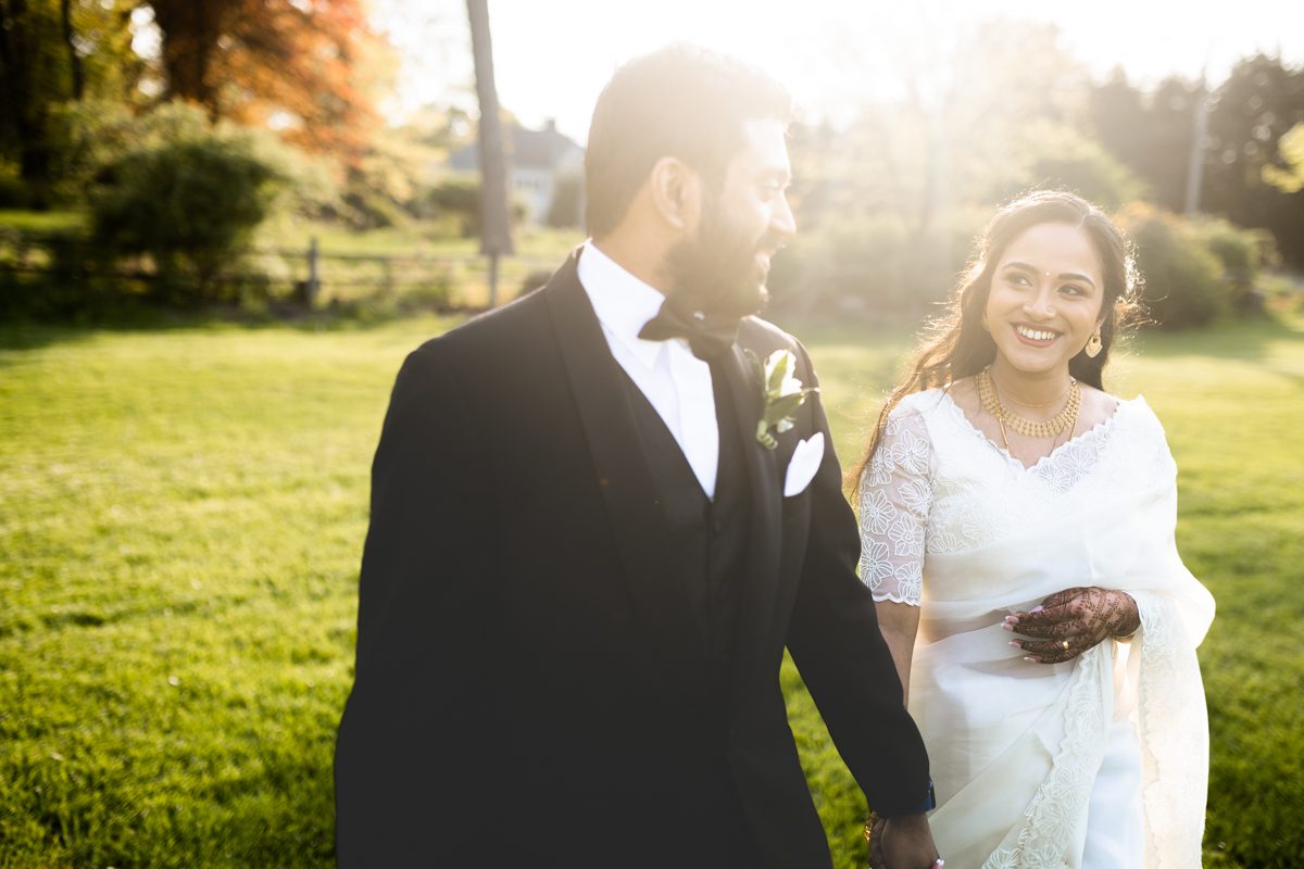 Whitby Castle Rye, NY Wedding by Pearl Paper Studio | Vrinda and Ajith Whitby Castle Rye NY Wedding Photographed by NY, LI and NJ Wedding Photography Studio Pearl Paper Studio. Celebrating Vrinda and Ajith today. Vrinda and Ajith both started at their homes where they finished their prep with prayers. Then Vrinda and Ajith headed over to St. Christophers in Buchanan NY for their Christian Indian wedding ceremony where Ajith covered Vrinda with veil and gifted a necklace as tradition. Then we took some formal photos at St. Christophers in Buschanan NY followed by wedding reception at Whitby Castle in Rye NY. Vrinda and Ajith caught the perfect sunset during their quick portrait time at Whitby Castle then fully enjoyed their cocktail hour and reception at Whitby Castle. Then the newly weds Vrinda and Ajith got sent off with a sparkler exit at Whitby Castle. Vrinda and Ajith wedding at Whitby Castle, NY captured by Steve from Pearl Paper Studio. Pearl Paper Studio is here to capture real emotions, fun couples with non-traditional wedding stories, now we are booking small intimate backyard wedding, outdoor tent wedding, farm wedding, elopements, nyc elopements. We are currently booking fall 2023 and 2024 weddings in NJ, NY, Brooklyn and Long Island.