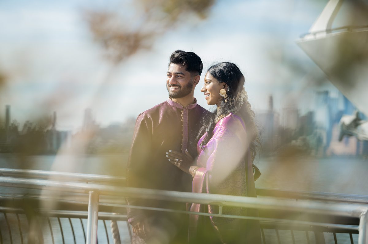 Lovely Hoboken waterfront engagement session with Ashley and Alvin. Ashely and Alvin started the Hoboken engagement session in their Indian traditional outfits then for later half of the Hoboken engagement session Ashley and Alvin changed into a dress and a suit. It was bit bright by Hoboken waterfront but with Ashley and Alvin we had fun exploring different backdrops of Hoboken, NJ. Ashley and Alvin's Hoboken NJ engagement session documented by MJ from Pearl Paper Studio. Pearl Paper Studio is here to capture real emotions, fun couples with non-traditional wedding stories, now we are booking small intimate backyard wedding, outdoor tent wedding, farm wedding, elopements, nyc elopements. We are currently booking fall 2023 and 2024 weddings in NJ, NY, Brooklyn and Long Island.