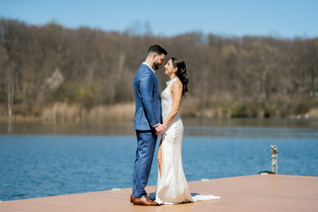 On April 25, I had the pleasure of documenting Gabriella and Joseph's wedding at the beautiful Rock Island Lake Club in Sparta, NJ. The venue provided a stunning backdrop for their special day, starting with Gabriella's elegant entrance in her simple yet stunning Jenny Yoon dress. The moment she walked down the dock for a first look with Joe was nothing short of magical.
Hope and Lilly from Strange Vine Studio truly outdid themselves with the decor. The outdoor ceremony area, set against the serene lake, was a picturesque setting for Gabriella and Joe's vows. Inside, the reception room was equally breathtaking, perfectly adorned to celebrate the newlyweds.
Gabriella and Joe's wedding day was filled with laughter and good vibes, all made even more memorable by the enchanting atmosphere of Rock Island Lake Club. The venue's natural beauty and impeccable amenities provided the perfect setting for this unforgettable celebration.

Gabriella and Joe Rock Island Lake Club Sparta NJ Wedding photographed by Steve from Pearl Paper Studio. Pearl Paper Studio is here to capture real emotions, fun couples with non-traditional wedding stories, now we are booking small intimate backyard wedding, outdoor tent wedding, farm wedding, elopements, nyc elopements. We are currently booking 2024 weddings in NJ, NY, Brooklyn and Long Island.
