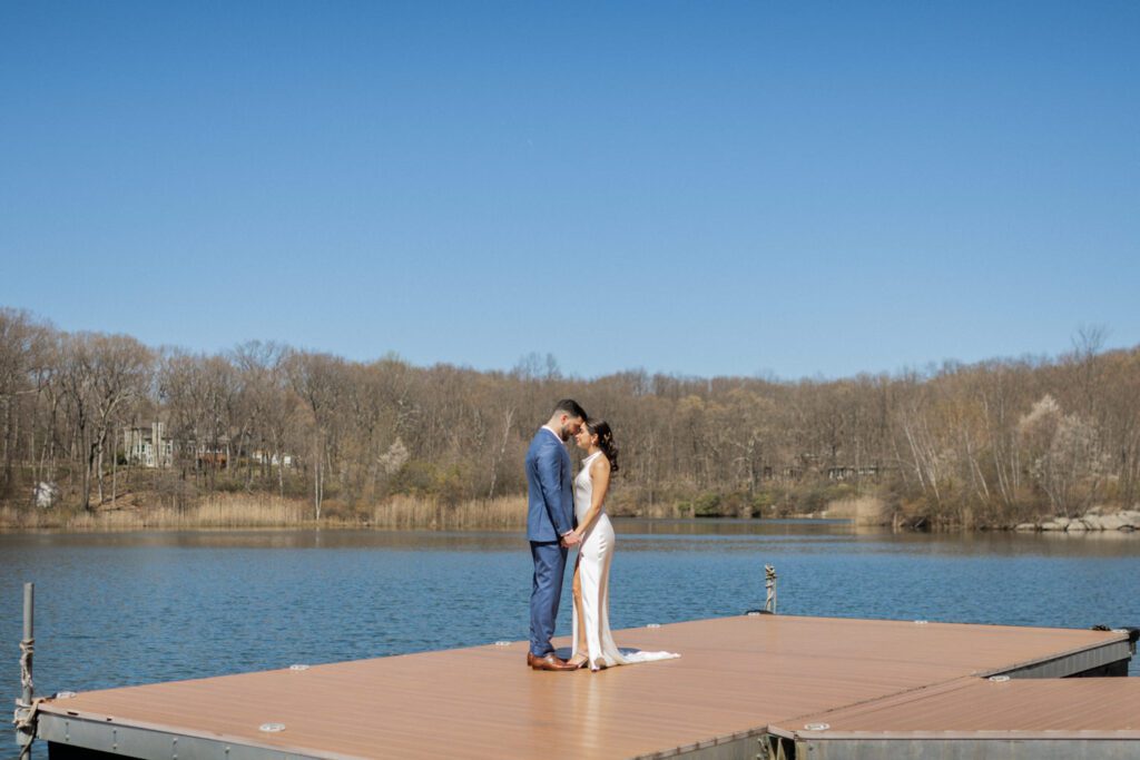 On April 25, I had the pleasure of documenting Gabriella and Joseph's wedding at the beautiful Rock Island Lake Club in Sparta, NJ. The venue provided a stunning backdrop for their special day, starting with Gabriella's elegant entrance in her simple yet stunning Jenny Yoon dress. The moment she walked down the dock for a first look with Joe was nothing short of magical.
Hope and Lilly from Strange Vine Studio truly outdid themselves with the decor. The outdoor ceremony area, set against the serene lake, was a picturesque setting for Gabriella and Joe's vows. Inside, the reception room was equally breathtaking, perfectly adorned to celebrate the newlyweds.
Gabriella and Joe's wedding day was filled with laughter and good vibes, all made even more memorable by the enchanting atmosphere of Rock Island Lake Club. The venue's natural beauty and impeccable amenities provided the perfect setting for this unforgettable celebration.

Gabriella and Joe Rock Island Lake Club Sparta NJ Wedding photographed by Steve from Pearl Paper Studio. Pearl Paper Studio is here to capture real emotions, fun couples with non-traditional wedding stories, now we are booking small intimate backyard wedding, outdoor tent wedding, farm wedding, elopements, nyc elopements. We are currently booking 2024 weddings in NJ, NY, Brooklyn and Long Island.
