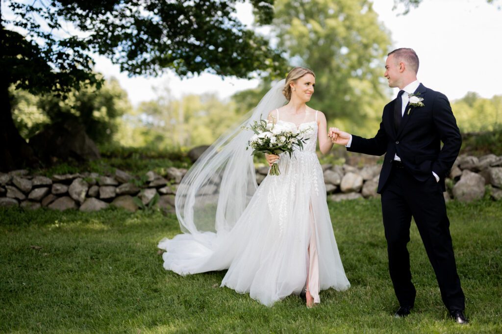 On June 2, 2024, I had the pleasure of photographing the beautiful wedding of Kristen Boonie and Ryan Piscopo at the stunning West Hills Country Club in Middletown, NY. The day was filled with love, joy, and picturesque moments that made for an unforgettable celebration.
Kristen and Ryan shared their first look on the lush green grass of West Hills Country Club, setting the tone for a day full of love and laughter. As we walked around the gorgeous property, we captured their wedding portraits amidst the vibrant blooms that provided a perfect backdrop for their special day.
The outdoor ceremony took place facing the golf course, offering a serene and peaceful view for all the guests. Blessed with amazing weather, the guests enjoyed the outdoors, reveling in the lush green field and the charming water fountain.
As the sun began to set, the reception music by Spin Doctor Entertainment filled the air, and guests moved into the beautifully set up tent. The floral decor by Deja Vu Floral Design added an extra touch of elegance, making the space under the expansive tent shine even more beautifully.
The reception began with Kristen and Ryan making their grand entrance, and the celebration kicked off in high spirits. Surrounded by their family and friends, they celebrated their love and new journey together at the picturesque West Hills Country Club.
West Hills Country Club provided a breathtaking setting for Kristen and Ryan's wedding day, with its lush landscapes, beautiful blooms, and elegant spaces. It was a day to remember, filled with love, laughter, and stunning scenery.
Kristen and Ryan West Hills Country Club NY Wedding photographed by MJ from Pearl Paper Studio. Pearl Paper Studio is here to capture real emotions, fun couples with non-traditional wedding stories, now we are booking small intimate backyard wedding, outdoor tent wedding, farm wedding, elopements, nyc elopements. We are currently booking 2024 weddings in NJ, NY, Brooklyn and Long Island.