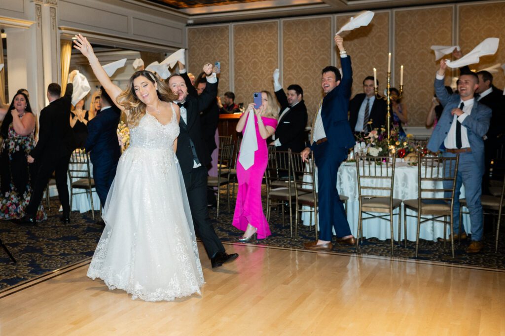 Kelly and John’s wedding day was a beautiful celebration filled with heartfelt moments, laughter, and joy. The day began at the Residence Inn by Marriott in New Rochelle, NY, where the bridal party and groomsmen got ready. While John and his groomsmen finished preparing at the hotel, Kelly and her bridesmaids headed to the stunning VIP Country Club for the final touches.
One of the most touching moments of the day was Kelly’s first look with her father at the VIP Country Club. It was an emotional moment filled with happy tears, setting the tone for the day’s heartfelt celebrations. Shortly after, John arrived with his groomsmen, and he and Kelly shared their first look.
Following their first look, Kelly and John strolled to the back of the venue to the picturesque waterfront for their couple’s portraits. The breeze brought a touch of adventure to the session, with a few splashes from the water adding to the fun! Despite the wind, Kelly and John were all smiles, radiating love and excitement for their big day.
As the photos wrapped up, guests began arriving for the outdoor ceremony at VIP Country Club’s beautiful ceremony space. With everyone seated, John eagerly awaited Kelly’s grand entrance. Their sweet ceremony was full of love, and they sealed their vows with a joyful kiss.
The celebration continued inside the VIP Country Club, where the couple’s first dance was made even more magical by sparklers lighting up the room. From there, Kelly and John were joined by their guests on the dance floor, and the party continued late into the night.
Kelly and John’s wedding was a true reflection of their love story—elegant, heartfelt, and filled with joy. I’m so grateful to have been part of their special day. Congratulations to the happy couple!
Kelly and John VIP Country Club NY Wedding photographed by MJ from Pearl Paper Studio. Pearl Paper Studio is here to capture real emotions, fun couples with non-traditional wedding stories, now we are booking small intimate backyard wedding, outdoor tent wedding, farm wedding, elopements, nyc elopements. We are currently booking 2025 and 2026 weddings in NJ, Manhattan, Hudson Valley NY, Brooklyn and Long Island.
