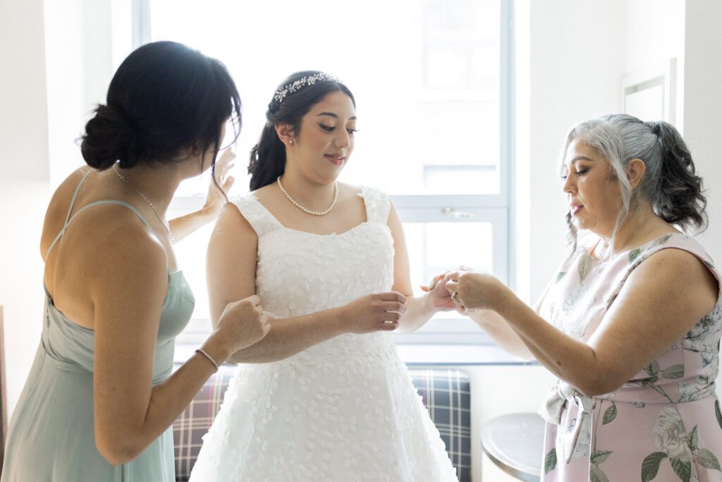 Nikki and Spencer’s wedding day was a perfect blend of heartfelt moments, breathtaking views, and joyous celebration in the heart of Manhattan.
The day began at the Hyatt Herald Square, where both the bride and groom got ready. Before heading out, Nikki and Spencer each shared emotional first-look moments with their parents, setting a beautiful tone for the day ahead.
The couple then made their way to the iconic New York Public Library and Bryant Park for their formal photos. Surrounded by their wedding party and family, the historic architecture and lush park provided a stunning backdrop for capturing unforgettable memories.
The ceremony took place on the rooftop Terrace at Midtown Loft & Terrace. This incredible space, featuring a retractable enclosed rooftop, offers a lush landscaped setting with sweeping 360-degree views of the Manhattan skyline. Guests were treated to vistas of iconic landmarks, including the Empire State Building and Marble Collegiate Church, making the moment even more magical.
After the ceremony, everyone moved indoors to the elegant Loft, which boasts high ceilings and large windows that frame the city’s skyline beautifully. The space perfectly complemented Nikki and Spencer’s vision for their wedding, providing a warm and stylish setting for the evening’s festivities.
The newlyweds shared laughter, happy tears, and countless unforgettable moments with their friends and family. As the night unfolded, the dance floor was alive with celebration, marking the perfect end to Nikki and Spencer’s extraordinary day at Midtown Loft & Terrace.
Congratulations, Nikki and Spencer! Your wedding was a true reflection of your love and joy, and I’m so honored to have captured it all.
Nikki and Spencer Midtown Loft and Terrace NY Wedding photographed by MJ from Pearl Paper Studio. Pearl Paper Studio is here to capture real emotions, fun couples with non-traditional wedding stories, now we are booking small intimate backyard wedding, outdoor tent wedding, farm wedding, elopements, nyc elopements. We are currently booking 2025 and 2026 weddings in NJ, Manhattan, Hudson Valley NY, Brooklyn and Long Island.