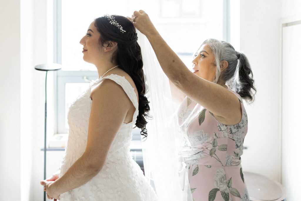 Nikki and Spencer’s wedding day was a perfect blend of heartfelt moments, breathtaking views, and joyous celebration in the heart of Manhattan.
The day began at the Hyatt Herald Square, where both the bride and groom got ready. Before heading out, Nikki and Spencer each shared emotional first-look moments with their parents, setting a beautiful tone for the day ahead.
The couple then made their way to the iconic New York Public Library and Bryant Park for their formal photos. Surrounded by their wedding party and family, the historic architecture and lush park provided a stunning backdrop for capturing unforgettable memories.
The ceremony took place on the rooftop Terrace at Midtown Loft & Terrace. This incredible space, featuring a retractable enclosed rooftop, offers a lush landscaped setting with sweeping 360-degree views of the Manhattan skyline. Guests were treated to vistas of iconic landmarks, including the Empire State Building and Marble Collegiate Church, making the moment even more magical.
After the ceremony, everyone moved indoors to the elegant Loft, which boasts high ceilings and large windows that frame the city’s skyline beautifully. The space perfectly complemented Nikki and Spencer’s vision for their wedding, providing a warm and stylish setting for the evening’s festivities.
The newlyweds shared laughter, happy tears, and countless unforgettable moments with their friends and family. As the night unfolded, the dance floor was alive with celebration, marking the perfect end to Nikki and Spencer’s extraordinary day at Midtown Loft & Terrace.
Congratulations, Nikki and Spencer! Your wedding was a true reflection of your love and joy, and I’m so honored to have captured it all.
Nikki and Spencer Midtown Loft and Terrace NY Wedding photographed by MJ from Pearl Paper Studio. Pearl Paper Studio is here to capture real emotions, fun couples with non-traditional wedding stories, now we are booking small intimate backyard wedding, outdoor tent wedding, farm wedding, elopements, nyc elopements. We are currently booking 2025 and 2026 weddings in NJ, Manhattan, Hudson Valley NY, Brooklyn and Long Island.