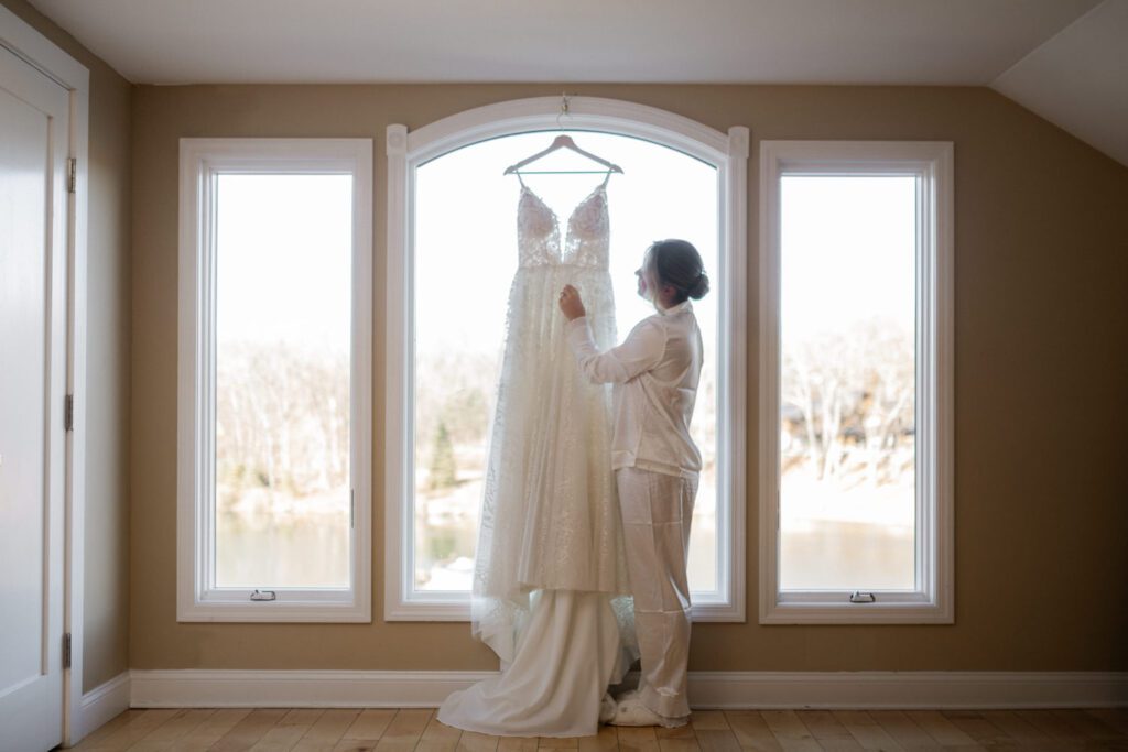 Emily and Frank Rock Island Lake Club, NJ 
Winter weddings are magical, and Emily and Frank’s November celebration at Rock Island Lake Club in Sparta, NJ, was the perfect example of just how enchanting they can be! Who says winter weddings can’t be fun? Despite the chilly weather, their special day was filled with warmth, laughter, and love—a true testament to their joyful spirits and the magic of this incredible venue.
Emily and Frank embraced the crisp November air with an outdoor ceremony by the picturesque lake at Rock Island Lake Club. The serene water, framed by the natural beauty of the surrounding landscape, created an unforgettable backdrop for their vows. Guests bundled up in cozy wraps and blankets, their smiles radiating as they witnessed the couple’s heartfelt promises. The venue’s dedicated team ensured every detail was perfectly executed, making the ceremony seamless.
After the ceremony, the celebration continued with one of the best cocktail hours in all of New Jersey. Rock Island Lake Club is renowned for its exceptional cuisine and creative presentation, and this event was no exception. Guests enjoyed an array of delicious hors d’oeuvres and drinks while mingling in the warm and inviting indoor spaces, thoughtfully designed to complement the venue’s lakeside charm.
The reception was a lively affair, with the dance floor packed from the first song to the last. Friends and family came together to celebrate Emily and Frank’s love, creating an atmosphere of pure joy. The stunning reception room at Rock Island Lake Club, with its elegant décor and large windows overlooking the lake, provided the perfect setting for a night of dancing, laughter, and unforgettable memories.
Rock Island Lake Club truly excels at hosting weddings year-round, but winter weddings here have a special kind of magic. From the attentive staff to the breathtaking views, every aspect of this venue enhances the celebration. Emily and Frank’s wedding day is proof that even on the coldest days, love and happiness can shine brighter than ever.
If you’re considering a winter wedding, Rock Island Lake Club is the perfect venue to bring your vision to life. Emily and Frank’s celebration was a testament to the beauty of the season and the power of love to warm even the chilliest of days.
Emily and Frank Rock Island Lake Club NJ Wedding photographed by Steve from Pearl Paper Studio. Pearl Paper Studio is here to capture real emotions, fun couples with non-traditional wedding stories, now we are booking small intimate backyard wedding, outdoor tent wedding, farm wedding, elopements, nyc elopements. We are currently booking 2025 and 2026 weddings in NJ, Manhattan, Hudson Valley NY, Brooklyn and Long Island.
