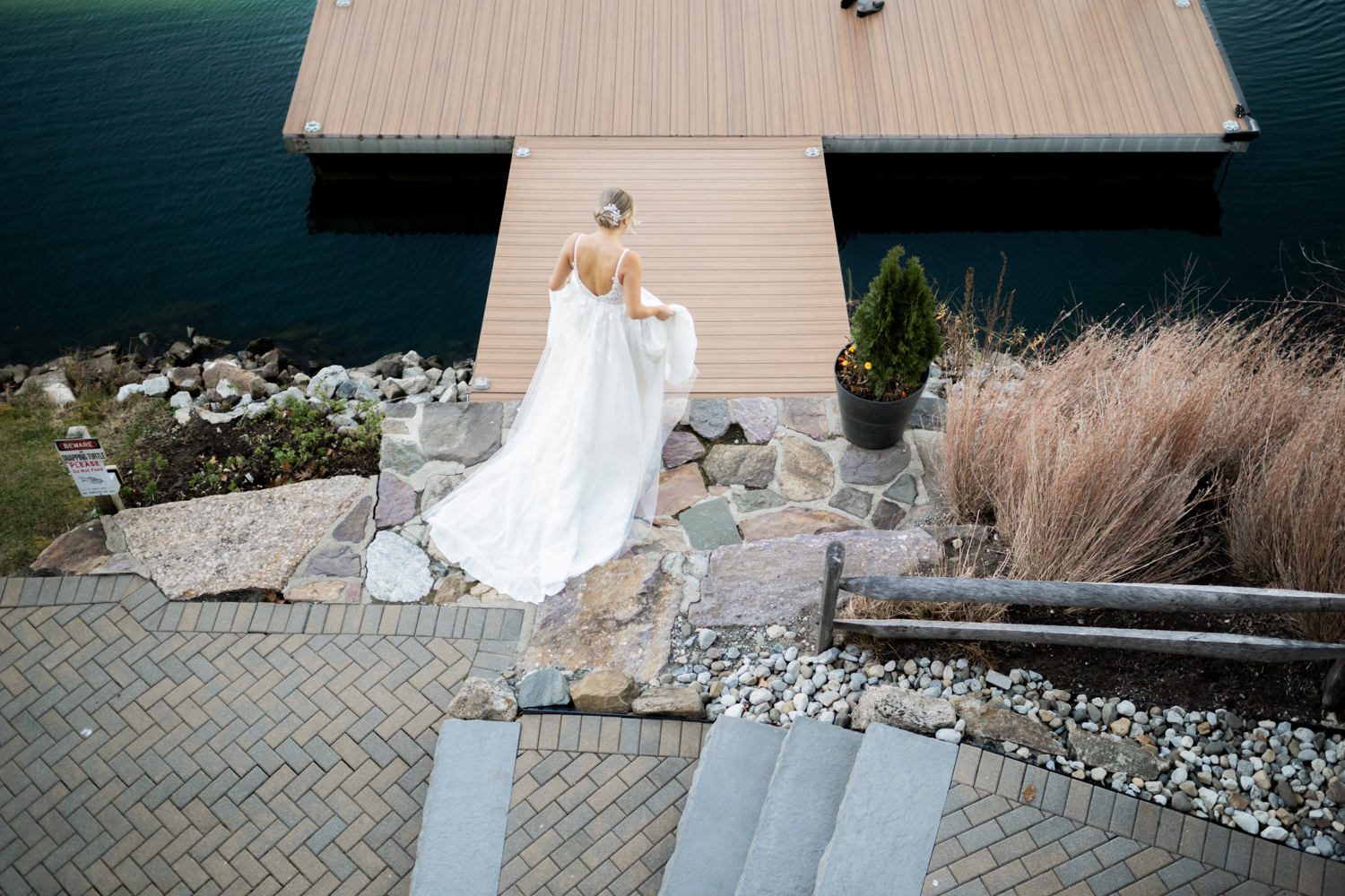 Emily and Frank Rock Island Lake Club, NJ Winter weddings are magical, and Emily and Frank’s November celebration at Rock Island Lake Club in Sparta, NJ, was the perfect example of just how enchanting they can be! Who says winter weddings can’t be fun? Despite the chilly weather, their special day was filled with warmth, laughter, and love—a true testament to their joyful spirits and the magic of this incredible venue. Emily and Frank embraced the crisp November air with an outdoor ceremony by the picturesque lake at Rock Island Lake Club. The serene water, framed by the natural beauty of the surrounding landscape, created an unforgettable backdrop for their vows. Guests bundled up in cozy wraps and blankets, their smiles radiating as they witnessed the couple’s heartfelt promises. The venue’s dedicated team ensured every detail was perfectly executed, making the ceremony seamless. After the ceremony, the celebration continued with one of the best cocktail hours in all of New Jersey. Rock Island Lake Club is renowned for its exceptional cuisine and creative presentation, and this event was no exception. Guests enjoyed an array of delicious hors d’oeuvres and drinks while mingling in the warm and inviting indoor spaces, thoughtfully designed to complement the venue’s lakeside charm. The reception was a lively affair, with the dance floor packed from the first song to the last. Friends and family came together to celebrate Emily and Frank’s love, creating an atmosphere of pure joy. The stunning reception room at Rock Island Lake Club, with its elegant décor and large windows overlooking the lake, provided the perfect setting for a night of dancing, laughter, and unforgettable memories. Rock Island Lake Club truly excels at hosting weddings year-round, but winter weddings here have a special kind of magic. From the attentive staff to the breathtaking views, every aspect of this venue enhances the celebration. Emily and Frank’s wedding day is proof that even on the coldest days, love and happiness can shine brighter than ever. If you’re considering a winter wedding, Rock Island Lake Club is the perfect venue to bring your vision to life. Emily and Frank’s celebration was a testament to the beauty of the season and the power of love to warm even the chilliest of days. Emily and Frank Rock Island Lake Club NJ Wedding photographed by Steve from Pearl Paper Studio. Pearl Paper Studio is here to capture real emotions, fun couples with non-traditional wedding stories, now we are booking small intimate backyard wedding, outdoor tent wedding, farm wedding, elopements, nyc elopements. We are currently booking 2025 and 2026 weddings in NJ, Manhattan, Hudson Valley NY, Brooklyn and Long Island.