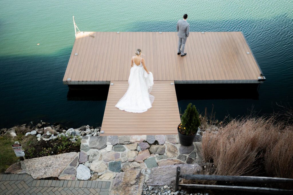 Emily and Frank Rock Island Lake Club, NJ 
Winter weddings are magical, and Emily and Frank’s November celebration at Rock Island Lake Club in Sparta, NJ, was the perfect example of just how enchanting they can be! Who says winter weddings can’t be fun? Despite the chilly weather, their special day was filled with warmth, laughter, and love—a true testament to their joyful spirits and the magic of this incredible venue.
Emily and Frank embraced the crisp November air with an outdoor ceremony by the picturesque lake at Rock Island Lake Club. The serene water, framed by the natural beauty of the surrounding landscape, created an unforgettable backdrop for their vows. Guests bundled up in cozy wraps and blankets, their smiles radiating as they witnessed the couple’s heartfelt promises. The venue’s dedicated team ensured every detail was perfectly executed, making the ceremony seamless.
After the ceremony, the celebration continued with one of the best cocktail hours in all of New Jersey. Rock Island Lake Club is renowned for its exceptional cuisine and creative presentation, and this event was no exception. Guests enjoyed an array of delicious hors d’oeuvres and drinks while mingling in the warm and inviting indoor spaces, thoughtfully designed to complement the venue’s lakeside charm.
The reception was a lively affair, with the dance floor packed from the first song to the last. Friends and family came together to celebrate Emily and Frank’s love, creating an atmosphere of pure joy. The stunning reception room at Rock Island Lake Club, with its elegant décor and large windows overlooking the lake, provided the perfect setting for a night of dancing, laughter, and unforgettable memories.
Rock Island Lake Club truly excels at hosting weddings year-round, but winter weddings here have a special kind of magic. From the attentive staff to the breathtaking views, every aspect of this venue enhances the celebration. Emily and Frank’s wedding day is proof that even on the coldest days, love and happiness can shine brighter than ever.
If you’re considering a winter wedding, Rock Island Lake Club is the perfect venue to bring your vision to life. Emily and Frank’s celebration was a testament to the beauty of the season and the power of love to warm even the chilliest of days.
Emily and Frank Rock Island Lake Club NJ Wedding photographed by Steve from Pearl Paper Studio. Pearl Paper Studio is here to capture real emotions, fun couples with non-traditional wedding stories, now we are booking small intimate backyard wedding, outdoor tent wedding, farm wedding, elopements, nyc elopements. We are currently booking 2025 and 2026 weddings in NJ, Manhattan, Hudson Valley NY, Brooklyn and Long Island.
