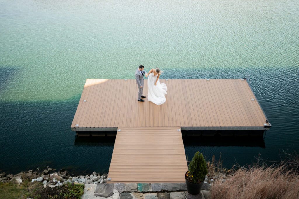 Emily and Frank Rock Island Lake Club, NJ 
Winter weddings are magical, and Emily and Frank’s November celebration at Rock Island Lake Club in Sparta, NJ, was the perfect example of just how enchanting they can be! Who says winter weddings can’t be fun? Despite the chilly weather, their special day was filled with warmth, laughter, and love—a true testament to their joyful spirits and the magic of this incredible venue.
Emily and Frank embraced the crisp November air with an outdoor ceremony by the picturesque lake at Rock Island Lake Club. The serene water, framed by the natural beauty of the surrounding landscape, created an unforgettable backdrop for their vows. Guests bundled up in cozy wraps and blankets, their smiles radiating as they witnessed the couple’s heartfelt promises. The venue’s dedicated team ensured every detail was perfectly executed, making the ceremony seamless.
After the ceremony, the celebration continued with one of the best cocktail hours in all of New Jersey. Rock Island Lake Club is renowned for its exceptional cuisine and creative presentation, and this event was no exception. Guests enjoyed an array of delicious hors d’oeuvres and drinks while mingling in the warm and inviting indoor spaces, thoughtfully designed to complement the venue’s lakeside charm.
The reception was a lively affair, with the dance floor packed from the first song to the last. Friends and family came together to celebrate Emily and Frank’s love, creating an atmosphere of pure joy. The stunning reception room at Rock Island Lake Club, with its elegant décor and large windows overlooking the lake, provided the perfect setting for a night of dancing, laughter, and unforgettable memories.
Rock Island Lake Club truly excels at hosting weddings year-round, but winter weddings here have a special kind of magic. From the attentive staff to the breathtaking views, every aspect of this venue enhances the celebration. Emily and Frank’s wedding day is proof that even on the coldest days, love and happiness can shine brighter than ever.
If you’re considering a winter wedding, Rock Island Lake Club is the perfect venue to bring your vision to life. Emily and Frank’s celebration was a testament to the beauty of the season and the power of love to warm even the chilliest of days.
Emily and Frank Rock Island Lake Club NJ Wedding photographed by Steve from Pearl Paper Studio. Pearl Paper Studio is here to capture real emotions, fun couples with non-traditional wedding stories, now we are booking small intimate backyard wedding, outdoor tent wedding, farm wedding, elopements, nyc elopements. We are currently booking 2025 and 2026 weddings in NJ, Manhattan, Hudson Valley NY, Brooklyn and Long Island.
