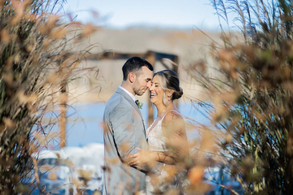 Emily and Frank Rock Island Lake Club, NJ 
Winter weddings are magical, and Emily and Frank’s November celebration at Rock Island Lake Club in Sparta, NJ, was the perfect example of just how enchanting they can be! Who says winter weddings can’t be fun? Despite the chilly weather, their special day was filled with warmth, laughter, and love—a true testament to their joyful spirits and the magic of this incredible venue.
Emily and Frank embraced the crisp November air with an outdoor ceremony by the picturesque lake at Rock Island Lake Club. The serene water, framed by the natural beauty of the surrounding landscape, created an unforgettable backdrop for their vows. Guests bundled up in cozy wraps and blankets, their smiles radiating as they witnessed the couple’s heartfelt promises. The venue’s dedicated team ensured every detail was perfectly executed, making the ceremony seamless.
After the ceremony, the celebration continued with one of the best cocktail hours in all of New Jersey. Rock Island Lake Club is renowned for its exceptional cuisine and creative presentation, and this event was no exception. Guests enjoyed an array of delicious hors d’oeuvres and drinks while mingling in the warm and inviting indoor spaces, thoughtfully designed to complement the venue’s lakeside charm.
The reception was a lively affair, with the dance floor packed from the first song to the last. Friends and family came together to celebrate Emily and Frank’s love, creating an atmosphere of pure joy. The stunning reception room at Rock Island Lake Club, with its elegant décor and large windows overlooking the lake, provided the perfect setting for a night of dancing, laughter, and unforgettable memories.
Rock Island Lake Club truly excels at hosting weddings year-round, but winter weddings here have a special kind of magic. From the attentive staff to the breathtaking views, every aspect of this venue enhances the celebration. Emily and Frank’s wedding day is proof that even on the coldest days, love and happiness can shine brighter than ever.
If you’re considering a winter wedding, Rock Island Lake Club is the perfect venue to bring your vision to life. Emily and Frank’s celebration was a testament to the beauty of the season and the power of love to warm even the chilliest of days.
Emily and Frank Rock Island Lake Club NJ Wedding photographed by Steve from Pearl Paper Studio. Pearl Paper Studio is here to capture real emotions, fun couples with non-traditional wedding stories, now we are booking small intimate backyard wedding, outdoor tent wedding, farm wedding, elopements, nyc elopements. We are currently booking 2025 and 2026 weddings in NJ, Manhattan, Hudson Valley NY, Brooklyn and Long Island.
