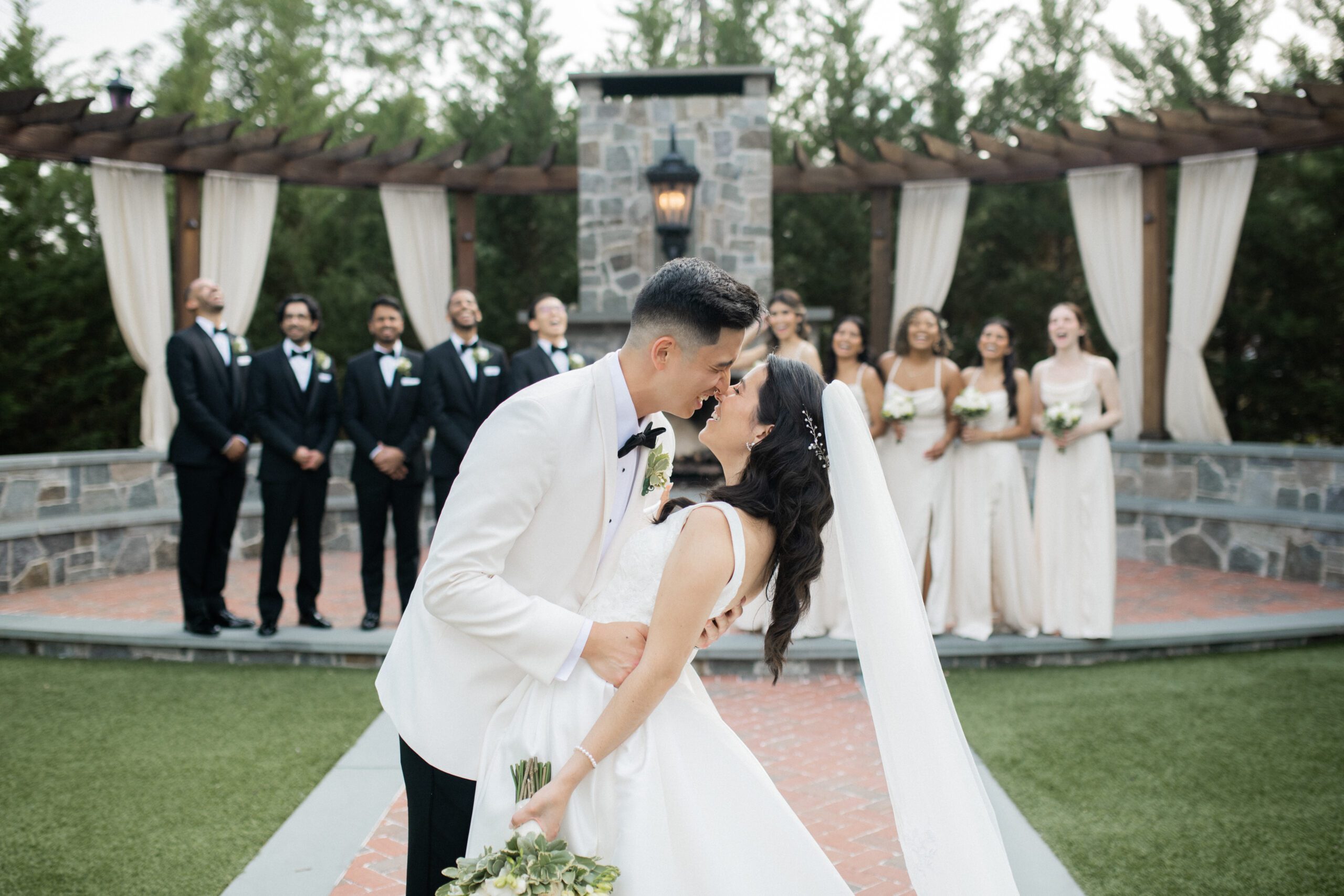 A groom dips a bride in the ceremony space of David's Country Inn, a rustic NJ wedding venue in Hackettstown, NJ.