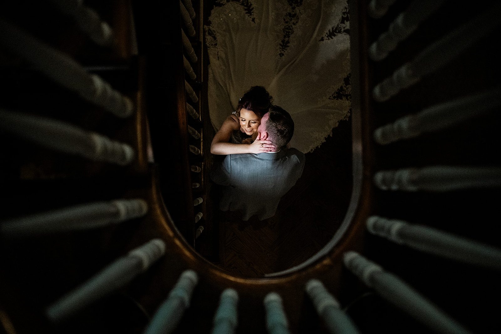 Bride & groom share an embrace at the base of the stairs during their portrait session at David's Country Inn in Hackettstown, NJ.