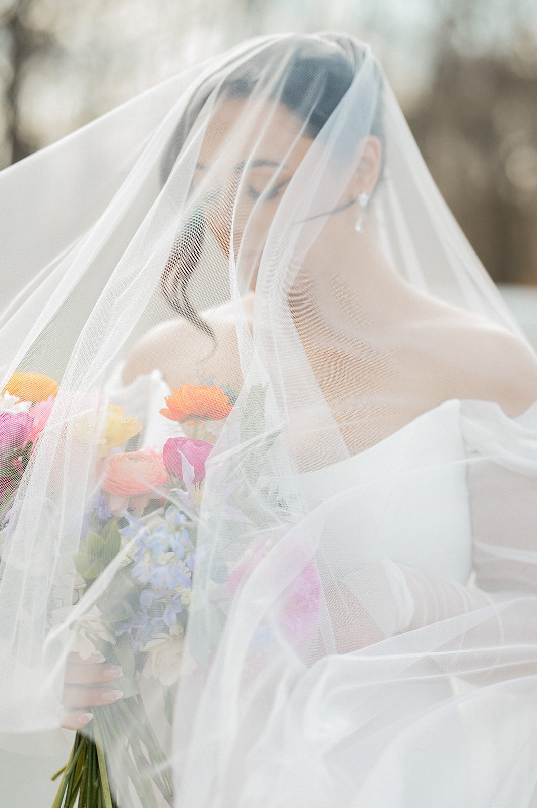 Bride holding her bouquet under a soft veil before her Rock Island Lake Club ceremony.