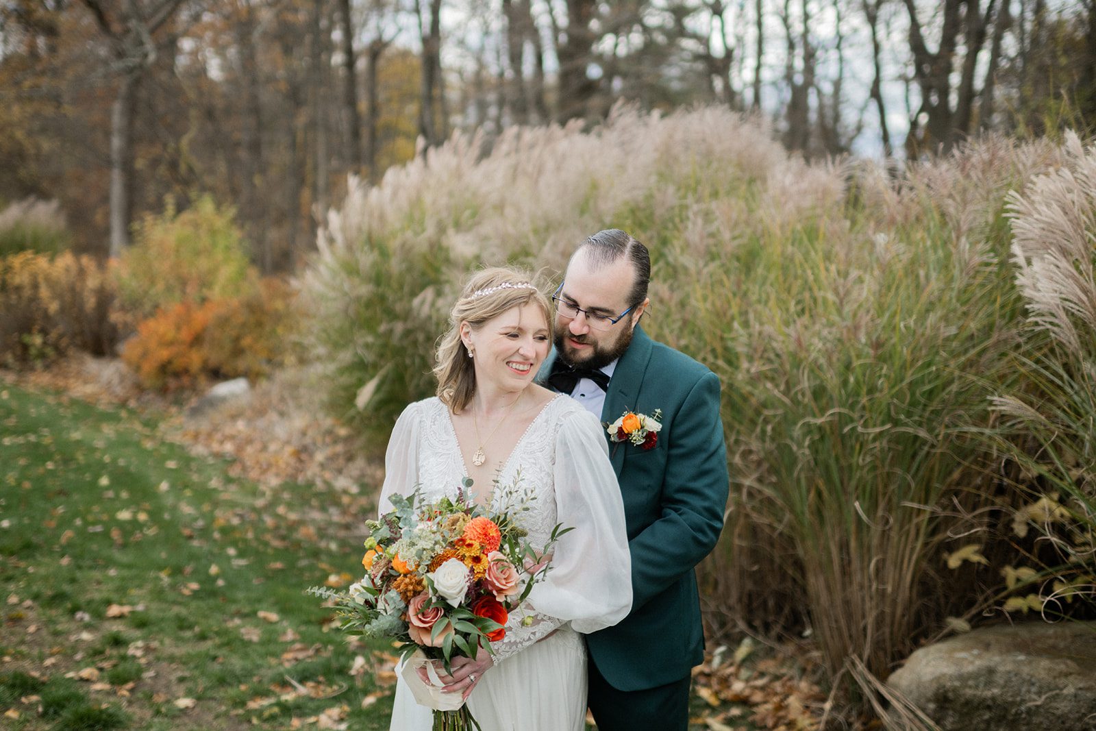 Maggie and Ian posed together in front of ornamental grasses.
