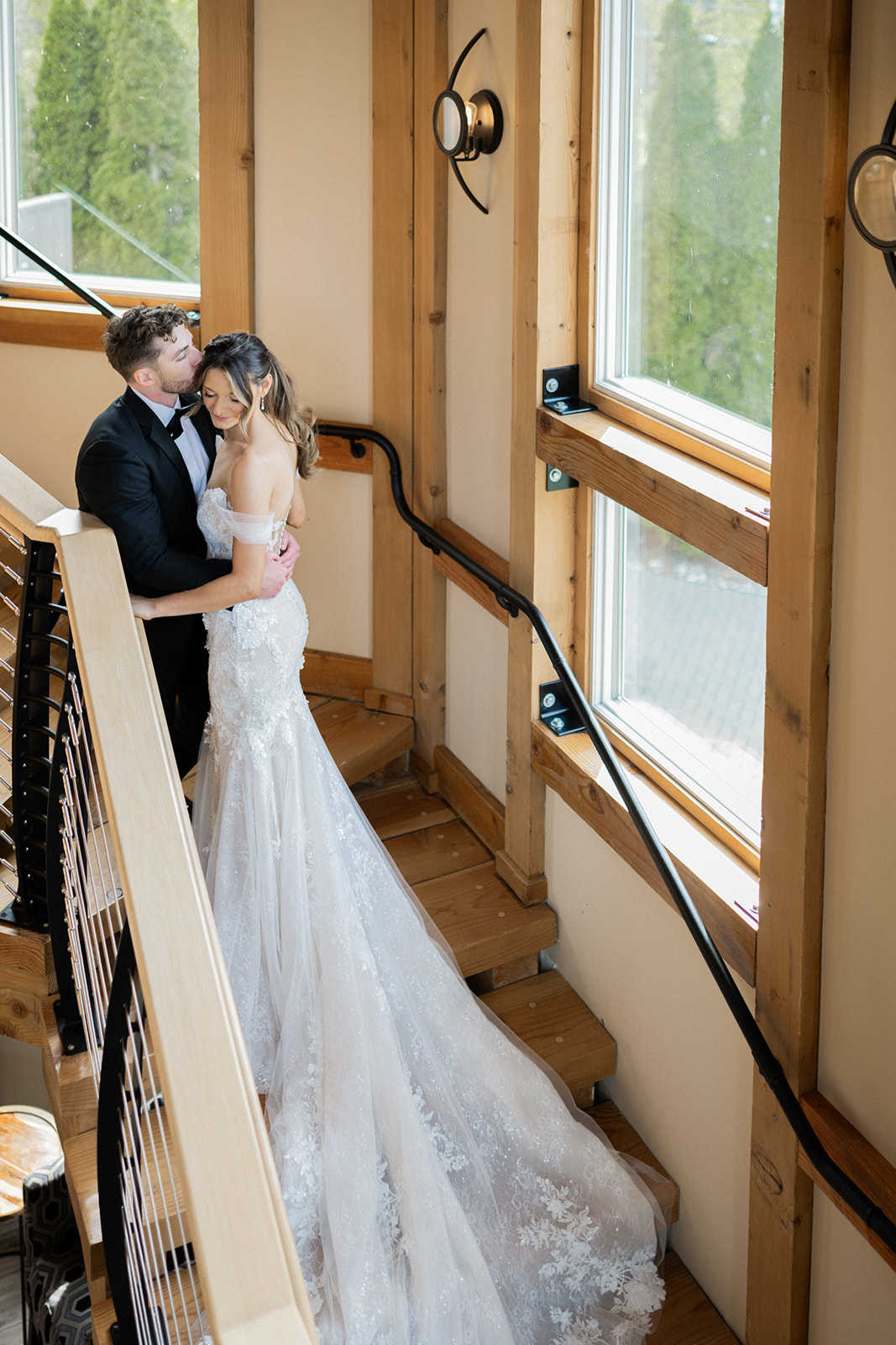 Heather and Michael share a quiet silhouette portrait by a dark window.