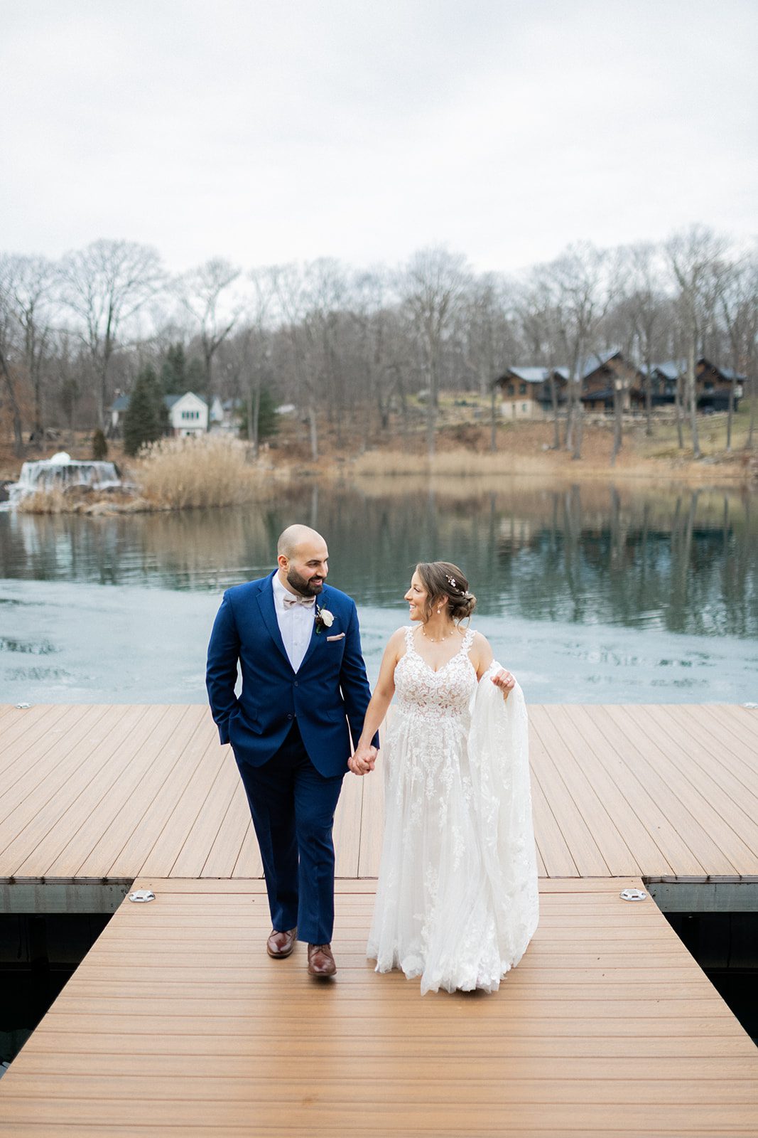 Cherylin and Nicholas walk hand in hand on the dock.