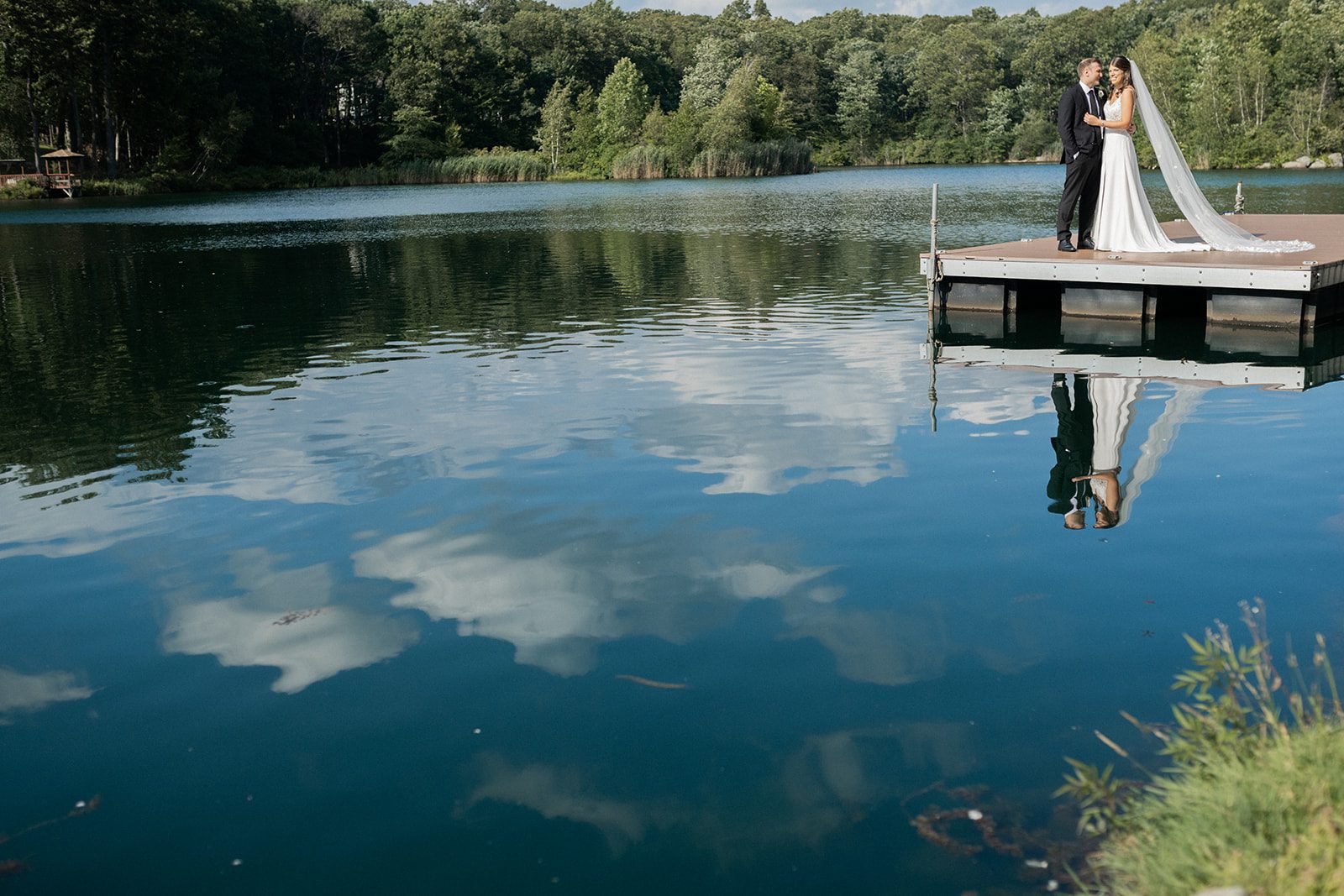 Megan and Michael stand on the lakeside dock at Rock Island Lake Club.