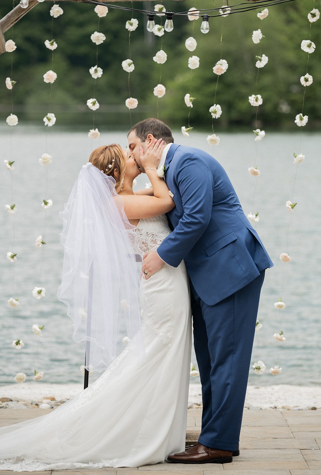Nicole and Ryan kiss beneath the ceremony arbor after exchanging vows.