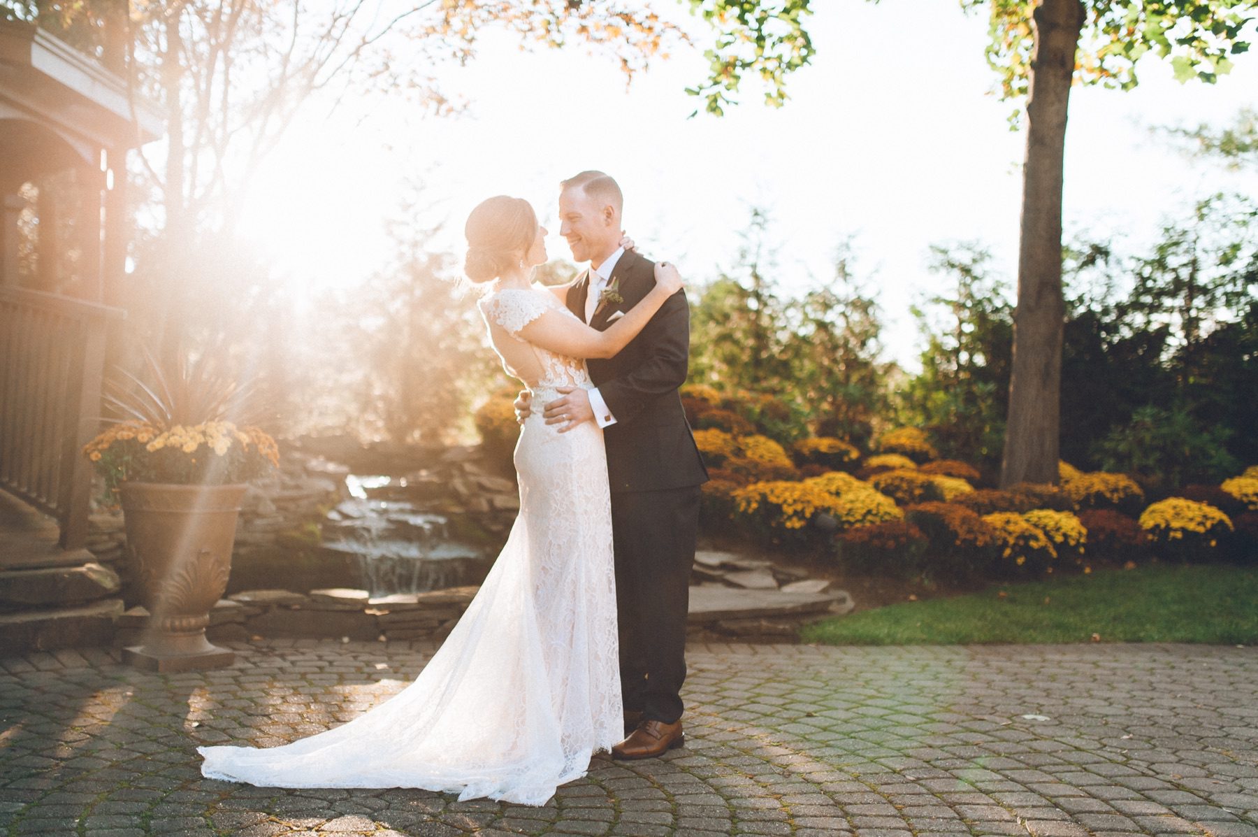 A couple holding each other in warm sunlight.